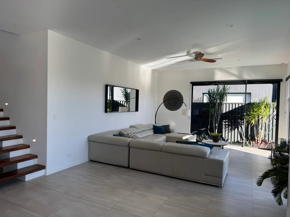 Bright living room with freshly painted white walls and an open patio